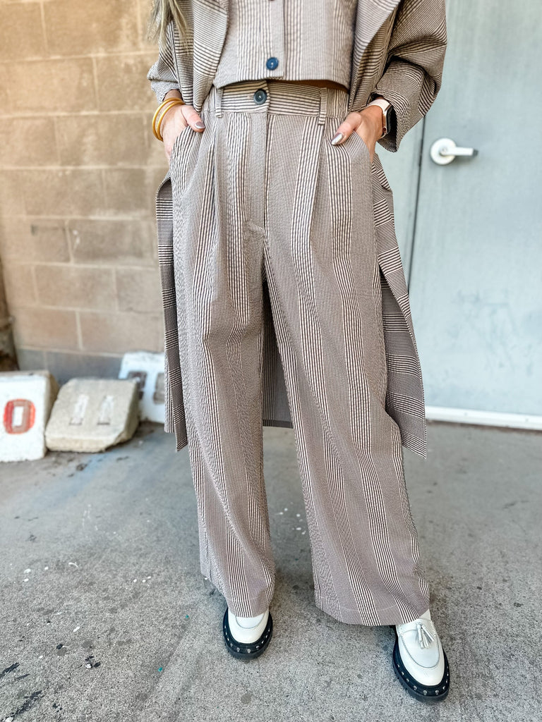 The Caroline Pants provide a chic and sophisticated look with their black and white striped fabric, wide leg design, and flattering fit. Perfect for formal occasions or a night out, these pants are sure to make a statement.