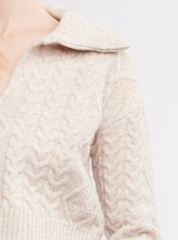 This season, wrap yourself with warmth and style in our cozy Malia Open Collar Sweater in birch, a beautiful neutral color. With a beautifully textured cable knit and timeless open collar, you'll look put-together even when it’s cold outside! Cut in a wedge shape, distinguished by its wide fit at the shoulders that gently tapers towards the hem.