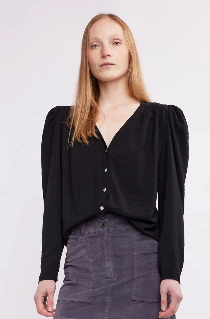 The sleek Eden Button V Blouse is the perfect addition to any wardrobe. Its chic v neck and button down design are complemented by flat padded shoulders to flatter any silhouette. Upgrade your look with this modern top.