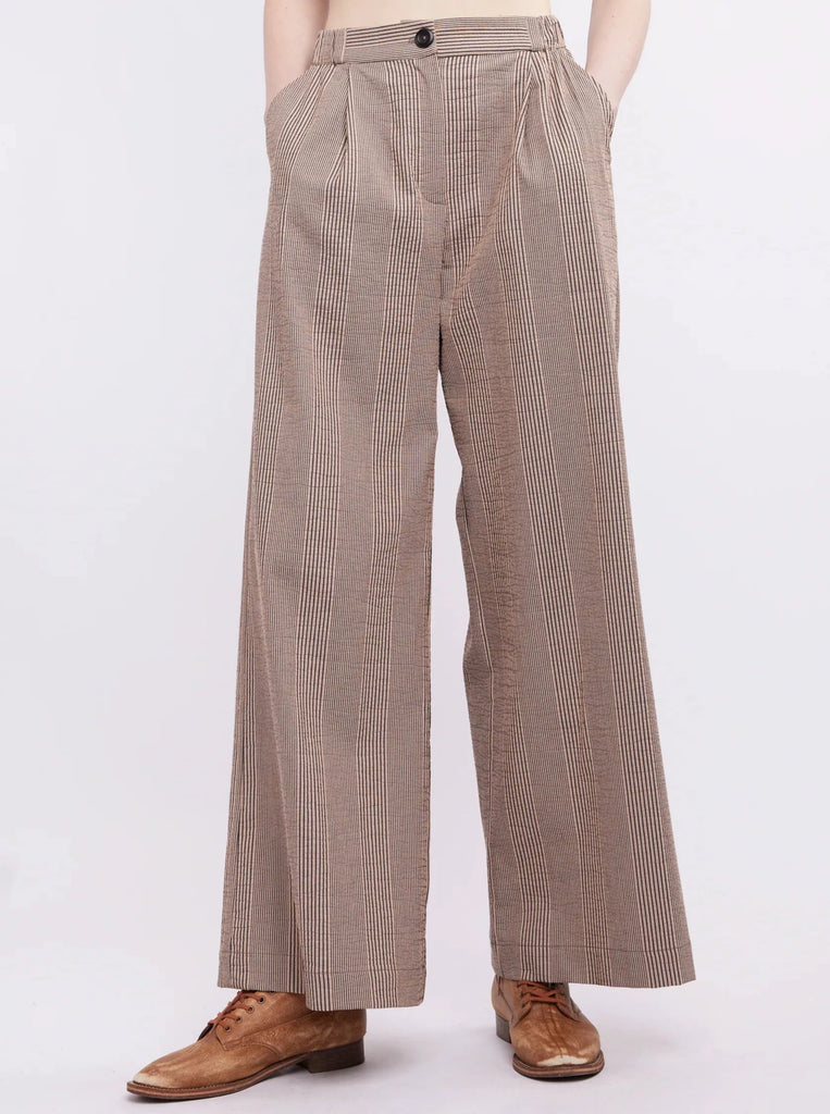 The Caroline Pants provide a chic and sophisticated look with their black and white striped fabric, wide leg design, and flattering fit. Perfect for formal occasions or a night out, these pants are sure to make a statement.