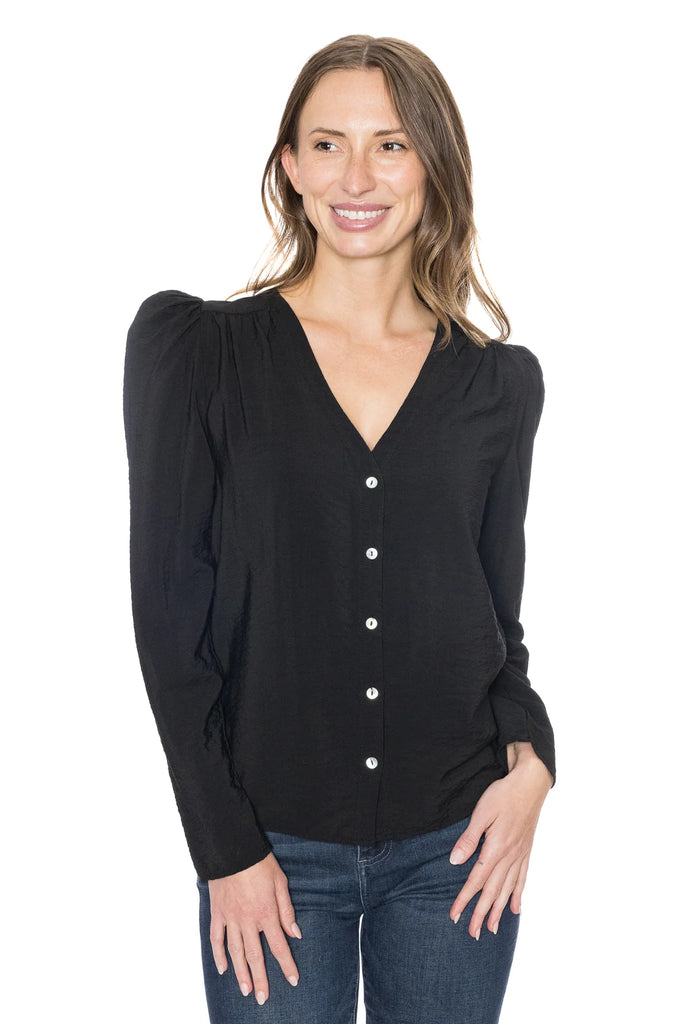 The sleek Eden Button V Blouse is the perfect addition to any wardrobe. Its chic v neck and button down design are complemented by flat padded shoulders to flatter any silhouette. Upgrade your look with this modern top.