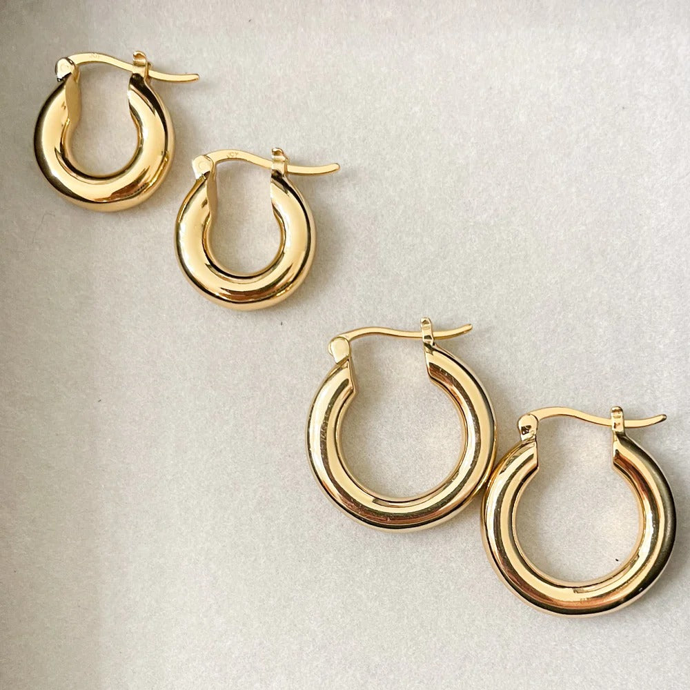 Our Best-selling silhouette now in a midi hoop! These thick gold hoops are perfect for your ear party. 20mm Earrings are of Gigi Midi Hoop and Baby Gigi Hoop