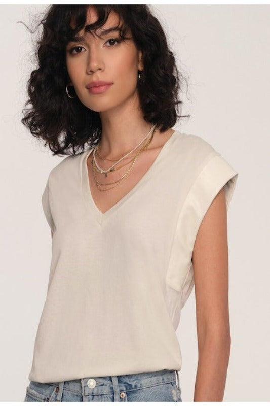 Women's Tee. Irina Tee in ivory color. The Irina Tee does the effortless-meets-polished thing so well. This soft crew neck tee faux leather detailing along the sleeves. Pair it with cut-offs or jeans for a perfect model-off-duty look. Fabric Content: 80% Cotton, 20% Polyester