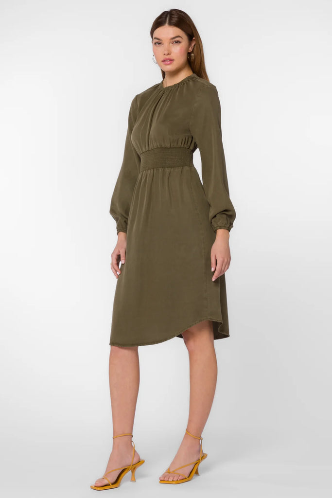 This modest below the knee dress is designed with long sleeves featuring elastic cuffs, and a smocked waist. Made with Tencel ™ fabric, this dress in olive color offers a beautiful, flattering draping.