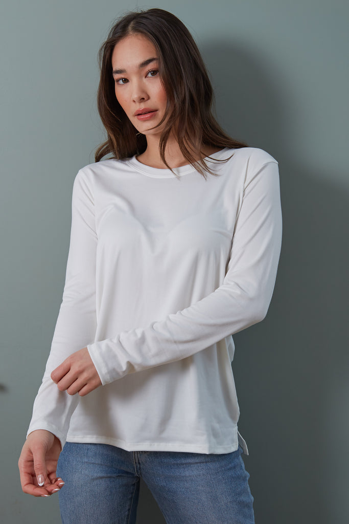 Suzanne Tee in Ivory. Your essential long sleeve tee! The Suzanne features a loose, relaxed fit with a crew neck and side split hem. A year-round necessity, the Suzanne is the perfect lightweight long sleeve tee.