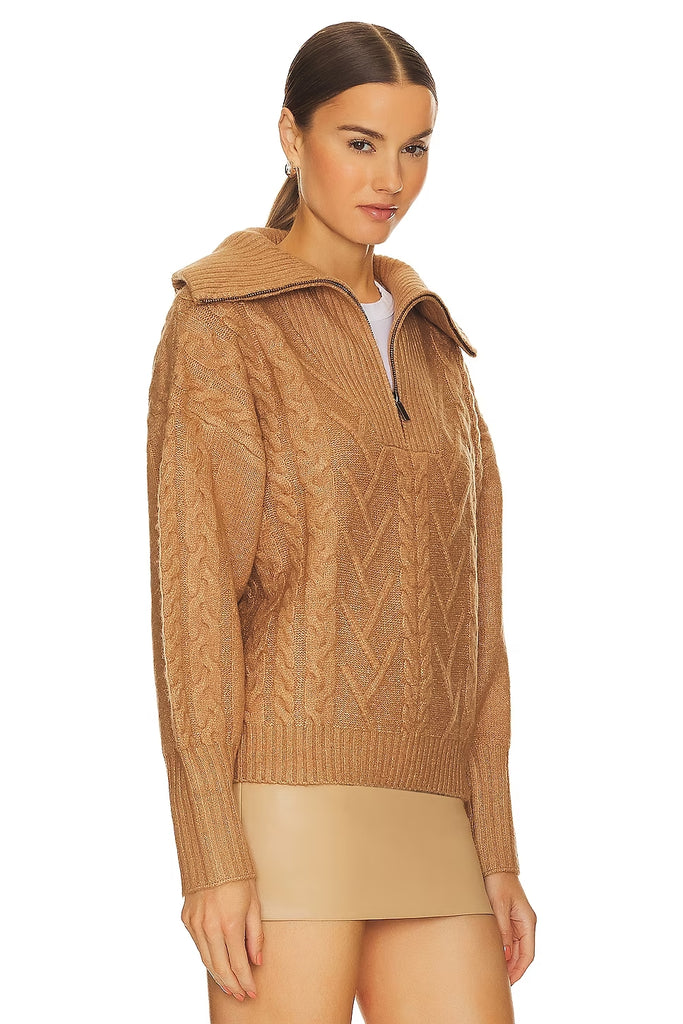 A must-have staple sweater, this cozy-chic caramel color pullover features a relaxed silhouette with a quarter-zip neckline, cable stitching, and rib knit trim. Layer over your favorite top as a sweater jacket. You'll be wearing it all season long with jeans, leggings, and trousers.