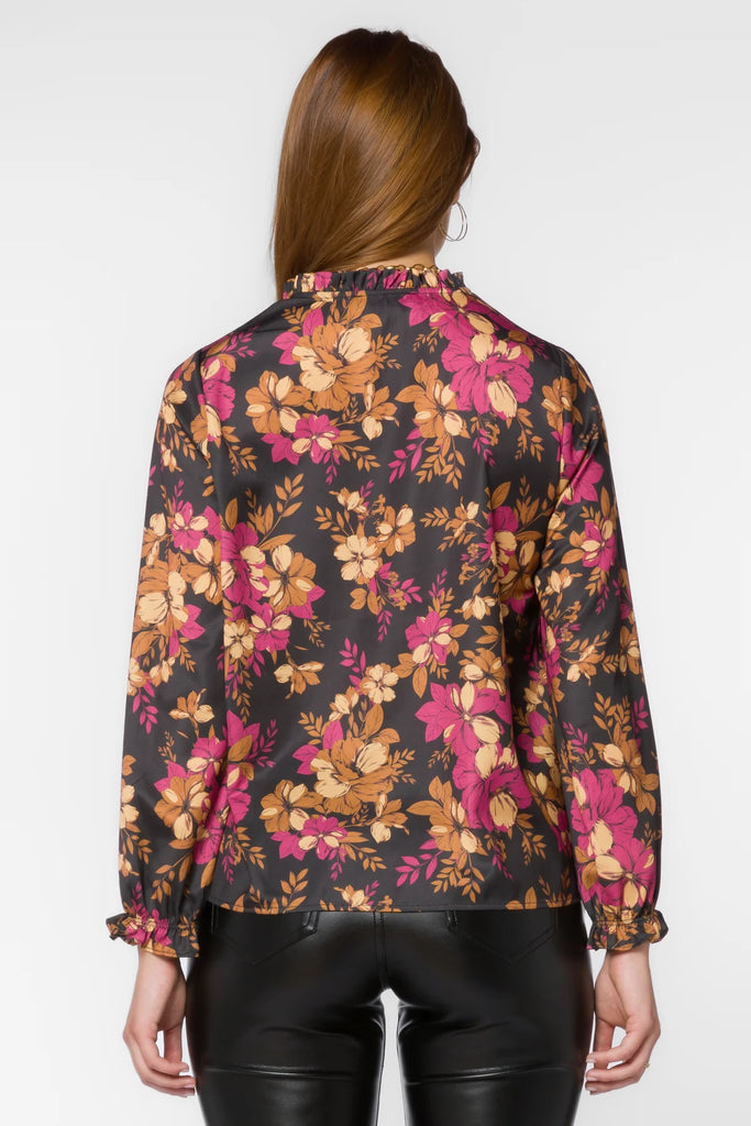 Maggie Blouse in multi gold floral black background features long sleeves, a pop-over design, a split v-neck, a high-low hem, and ruffle details for added style. Its lightweight fabric and flattering fit make this top a great addition to any wardrobe.