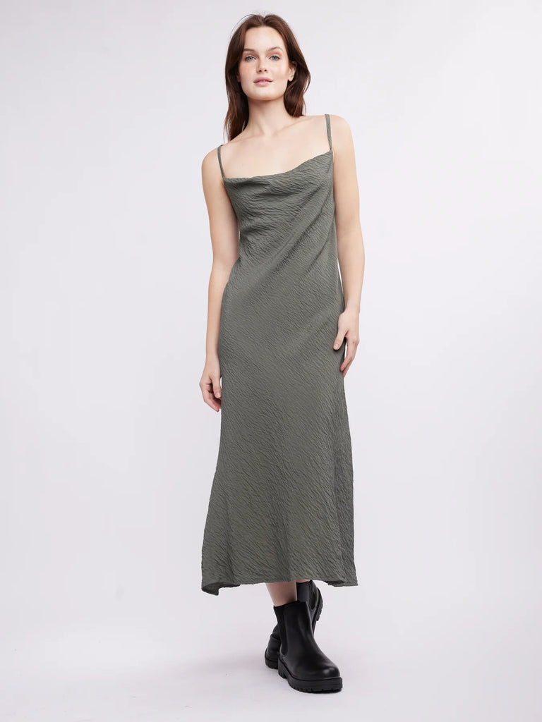 Introducing the Norah Midi Slip Dress: a timeless, luxuriously textured piece crafted from sustainable fabric. Featuring a cowl neckline and adjustable straps, this elegant midi dress brings a sophisticated, contemporary edge to any wardrobe. Add effortless style to your look with this timeless essential.