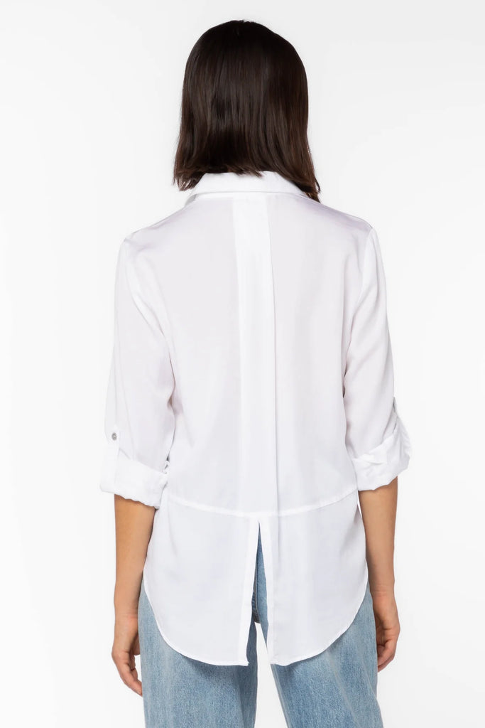 Women's Riley button down shirt in white. Rolled tab sleeve button down collared shirt, double chest pockets, split back tail.