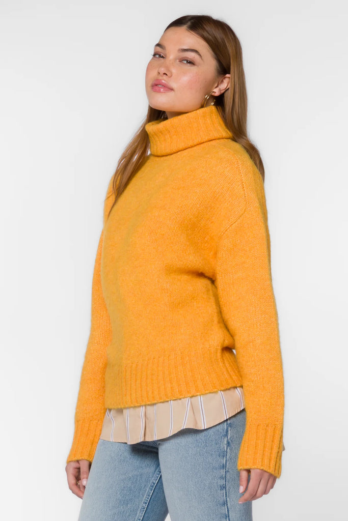 The Tillie Sweater in marled orange is the perfect addition to your wardrobe this season. Crafted with long sleeves, a turtleneck, drop shoulder and ribbed cuff and hem, this sweater will keep you warm and stylish throughout the cold months. 