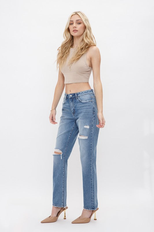 Rigid High Rise 90s Straight. Look trendy and fun in this straight fit jeans with ripped and distressed details.Fabric Content: 100% Cotton