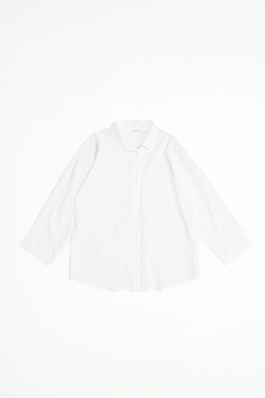The Lila button up shirt in white. Cut in an oversized shape, it's detailed with a single front patch pocket, wide hem sleeves with elongated sleeve tabs and a pleated back. Crafted from a soft, cupro fabric for that cool feeling. 86% Rayon, 14% Polyester