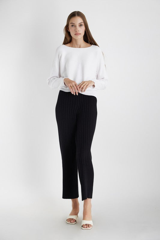 Women's knit top in white. The Estella Top is soft knit, dolman sleeve top with a draped bateau neckline and a rounded silhouette. Its horizontal ribbing adds some texture and detail. Perfect for the transitional season. 51% Viscose, 27% Polyester, 22% Nylon