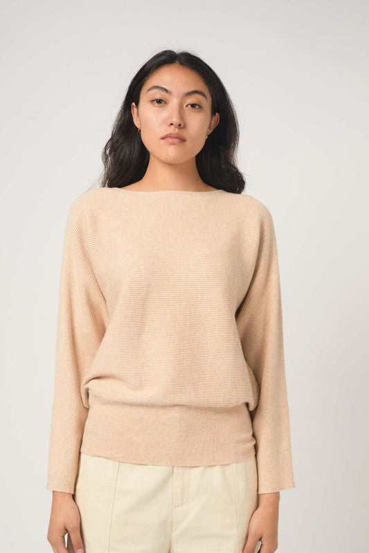 Women's knit top in biege. The Estella Top is soft knit, dolman sleeve top with a draped bateau neckline and a rounded silhouette. Its horizontal ribbing adds some texture and detail. Perfect for the transitional season. 51% Viscose, 27% Polyester, 22% Nylon