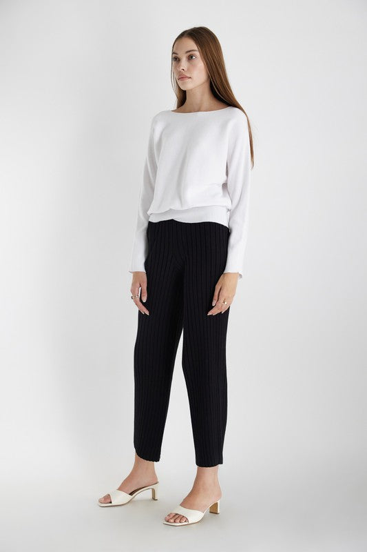 Women's knit top in white. The Estella Top is soft knit, dolman sleeve top with a draped bateau neckline and a rounded silhouette. Its horizontal ribbing adds some texture and detail. Perfect for the transitional season. 51% Viscose, 27% Polyester, 22% Nylon