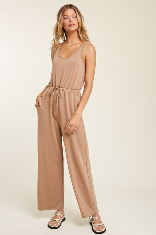 French Terry Knit Jumpsuit with Drawstring in Mocha color. This ultra soft French knit jumpsuit is a relaxed fit with a drawstring cord to make a sporty look. Fabric Content: 63% POLYESTER, 33% RAYON, 4% SPANDEX