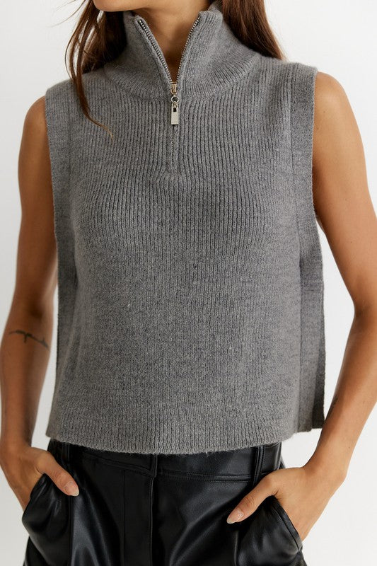 Women's Renn vest in heather grey. The Renn Vest features a high neck with half zip closure, that opens to a feature collar. With a relaxed fit and neutral colorway, this vest offers versatile styling options to wear as a stand-alone piece or layer with a soft long sleeve. Fabric Content: 60% Acrylic, 40% Nylon