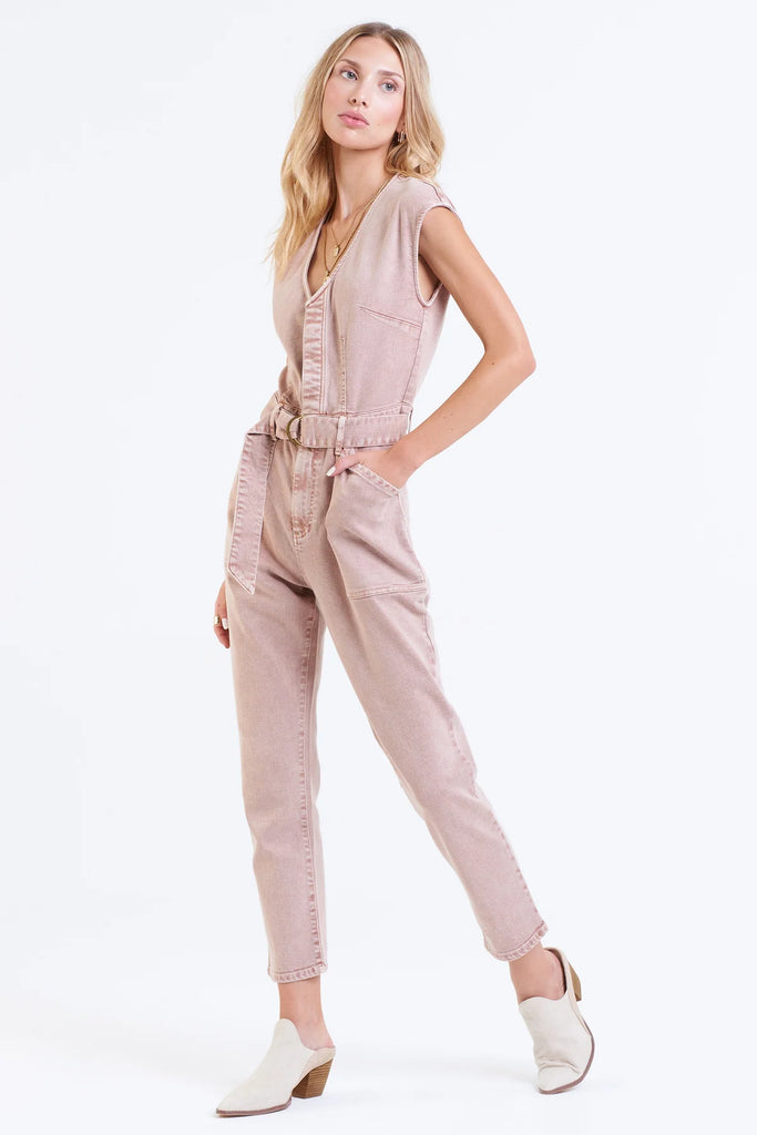 Women's Denim Jumpsuit. Nicole Color denim jumpsuit in rose dust color. Cropped length with body darts for support, v-neck & sleeveless with hidden placket button front & utility cargo pockets.Fabric Content: 90% COTTON 8% POLYESTER 2% SPANDEX