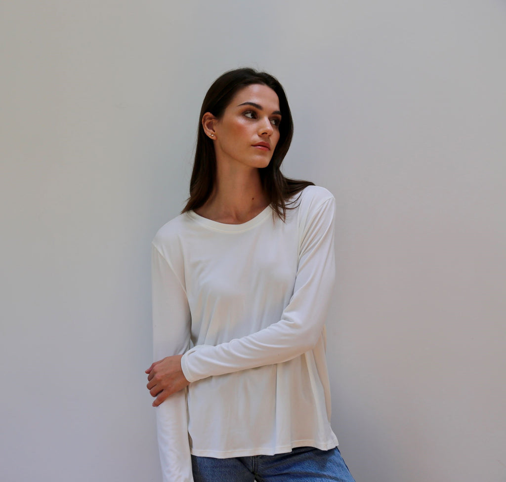 Suzanne Tee in Ivory. Your essential long sleeve tee! The Suzanne features a loose, relaxed fit with a crew neck and side split hem. A year-round necessity, the Suzanne is the perfect lightweight long sleeve tee.