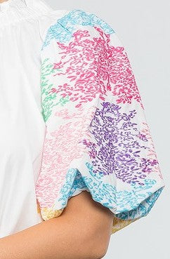 Close up photo of sleeve of Poplin intricate embroidered Balloon Short Sleeve top in white. Fabric Content: 100% Polyester