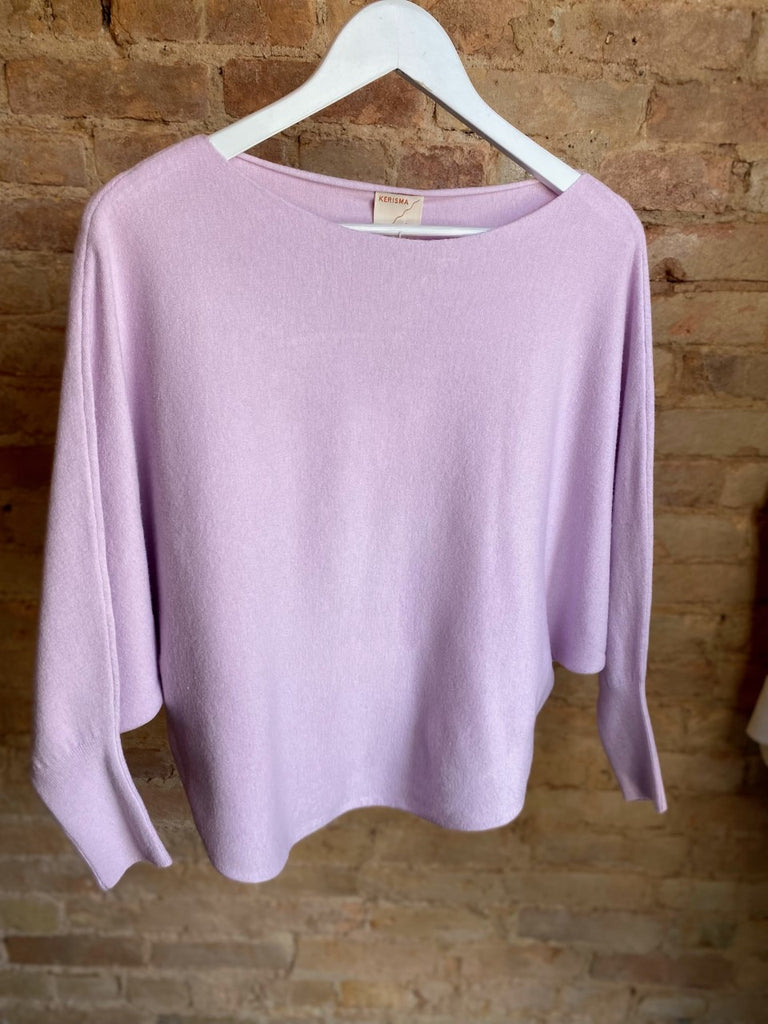 Women's Sweater in lavender. Boat neck top with 3/4 length dolman sleeves and curved sweep. Fabric Content: 20% modal, 25% nylon, 30% polyester, 25% viscose